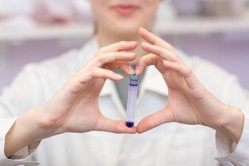 Fototapeta na wymiar Woman lab technician holding test tube