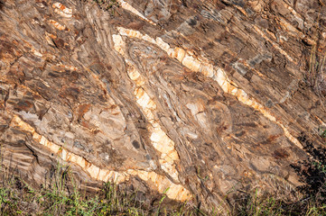 Fragment of granite rock with a natural pattern in the form of the letter 