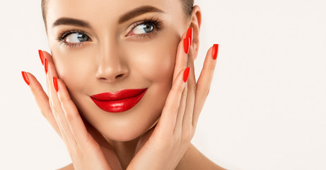 Beautiful girl showing red  manicure nails & lips. Woman Makeup, beauty and cosmetics - obrazy, fototapety, plakaty