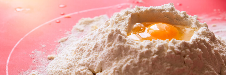 Mountain flour with deepening and egg. Kneading the dough