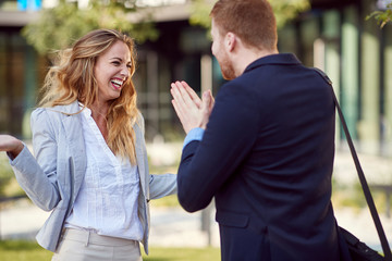 caucasian businessman begging his female partner. fun, persuading, begging,