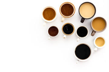 Lots of coffee on white desk top-down space for text