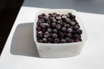 Frozen berry in box on white table