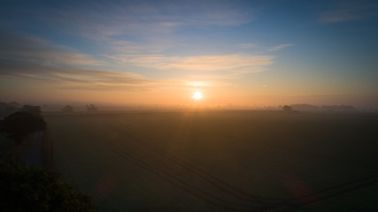 sunrise over farmland and fields