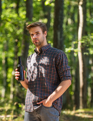 man drink beer in forest. relax on summer picnic weekend. camping season begin. he loves hiking. tourism adventure concept. drinking beer in camping. do not leave garbage in forest. ecology pollution