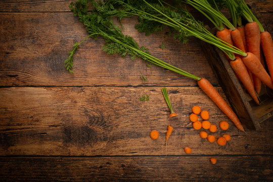 Farm Fresh Carrots on a Rustic Wooden Table Top View Flat Lay
