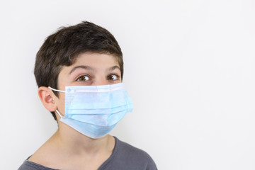 Covid-19 coronavirus barrier gesture child with a surgical mask on the face