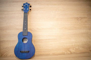 acoustic ukulele on wooden background