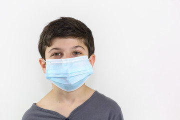 Covid-19 coronavirus barrier gesture child with a surgical mask on the face
