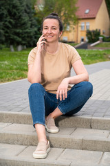 Cheerful young woman talking on phone