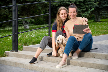 Happy smiling mother and daughter resting in the park