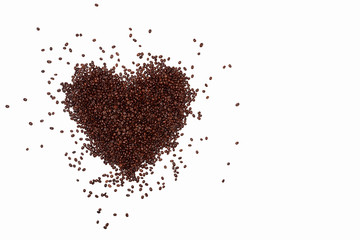 lots of coffee beans scattered in a heart shape on a white background. fried brown coffee beans are scattered on the surface, lovers of coffee drinks, love of coffee