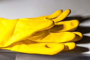 Yellow rubber gloves for safe cleaning, protection of the hands while performing tasks involving...