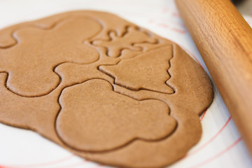 Christmas joy of cutting out cookies out of gingerbread dough, with a variety of decorative cutters