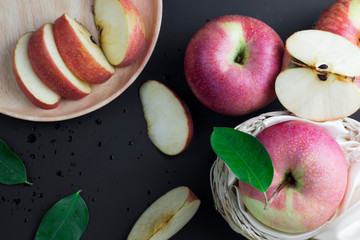 Ripe red apples and leaf Top view with text copy space in black wooden background