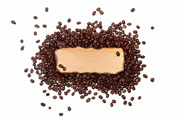 Obraz premium coffee logo with an empty space for text. sign with coffee beans. craft paper lies on a handful of brown coffee beans. coffee abstraction on a white background with an empty space