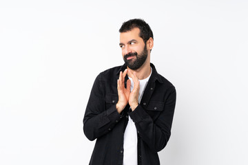 Young man with beard over isolated white background scheming something