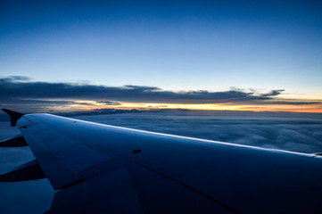 Sunset view over the clouds from an airplane