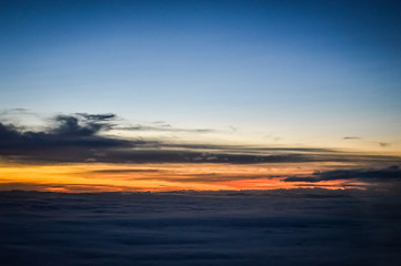 Sunset view over the clouds from an airplane