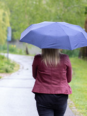 A woman holding an umbrella on a rainy day in a park
