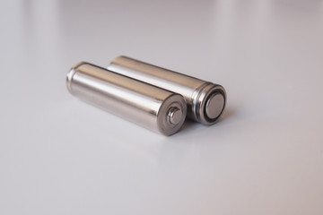 Two aa gray batteries on a white background