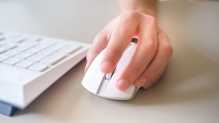 close up hand man using mouse and computer at home with morning light.