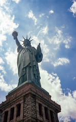 Statue of Liberty against cloudy blue sky in summer 