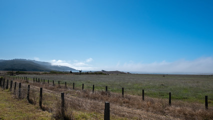 Fototapeta na wymiar Highway 101 under the sun, with fences and fields, california
