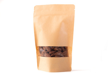 brown paper doypack stand up food pouch filled with almond with window zipper on white background