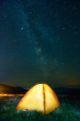 Night sky and yellow tent with light