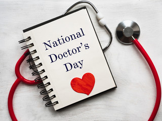Happy national Doctor's Day. Beautiful card. Isolated background, wooden surface. Congratulations...