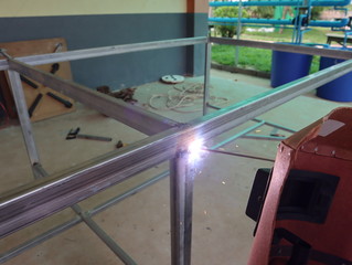 Male in face mask welds with arc welding.