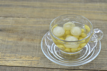 Lotus tea, longan in cup nutritious delicious on wooden table