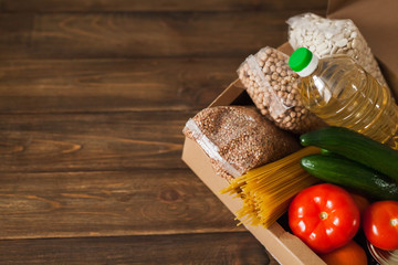 Food supplies. Stock of non-perishable products and vegetables in box. Sunflower oil, buckwheat, pasta, beans, chickpeas, canned food. Food Delivery, Donation, Coronavirus Quarantine. Copyspace.