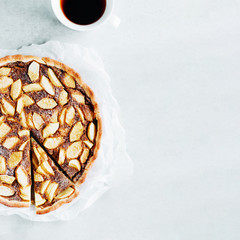 Homemade apple pie with cup of tea on white background. Square format.