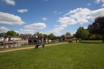 People sat by The Thames in Abingdon, Oxfordshire, UK