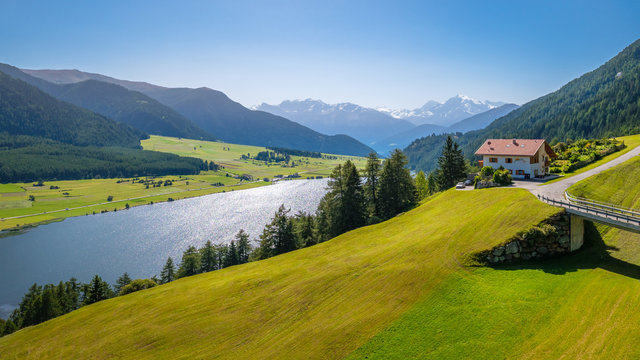 View of Lake della Muta (German: Haidersee) and Ortler Mountains in Val Venosta in the region Alto Adige in Italy. The lake lies next to Lake Resia (German: Reschensee)