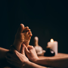 Professional foot massage close up. Authentic shot of luxury spa treatment. Charming light. Shallow...