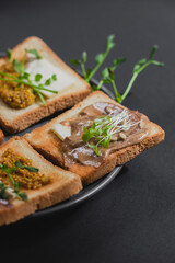 Variety of sandwiches for breakfast, snack, appetizers with fried egg, peanut paste, pea microgreen. Flat lay, top view