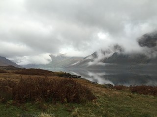 Lake District with reflection in lake with low clouds over the mountains  in the Autumn with water like glass