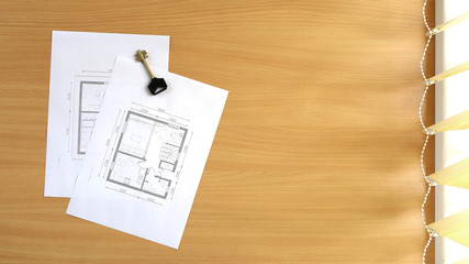 Floor plan of the house is located on the table. Top view with copy space