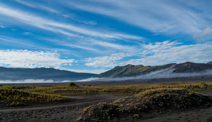 the surrounding area of Mount Bromo with a cloudy and mystic mood early in the morning on Java in Indonesia