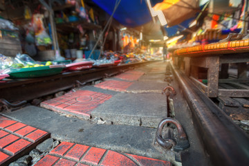 .Thailand, Samut Songkhrami, Mae Klong railway market also called Siang Tai. Tourists walk along the train tracks bltkf. and make purchases from local sellers