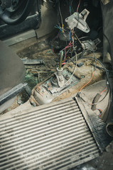 Fototapeta premium inside vertical view to gear shifter and wires of a broken and disassembled interior of old abandoned car at dump