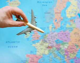 Toy plane and Europe map on the background.