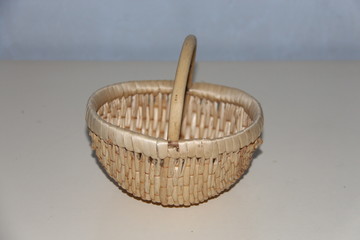 Closeup of handmade picnic basket with bamboo, empty wicker basket isolated on gray background