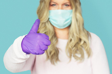 WOMAN WITH MASK AND PROTECTIVE GLOVES