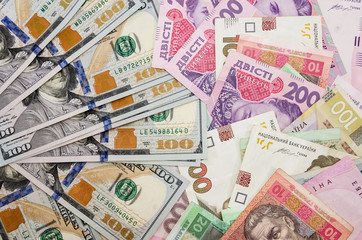 Background with dollars and different hryvnia.