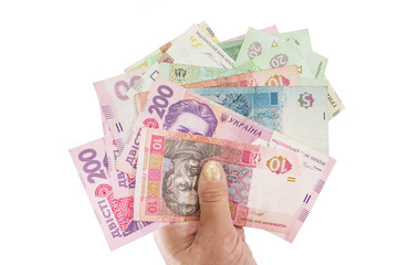 different hryvnias in hand isolated on a white background. Close-up. View from above.