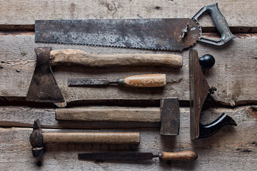 old carpentry tools on wooden background